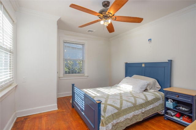 bedroom with multiple windows, dark wood-type flooring, and ornamental molding