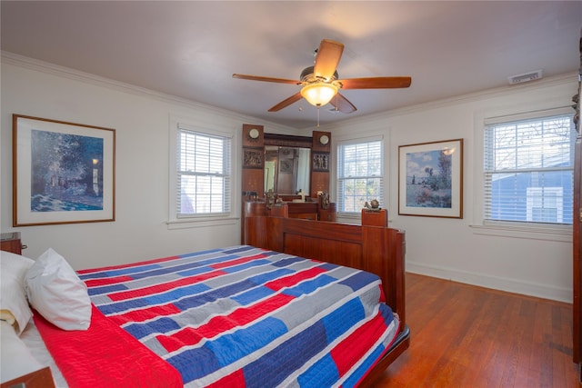 bedroom with multiple windows, crown molding, dark wood-type flooring, and ceiling fan