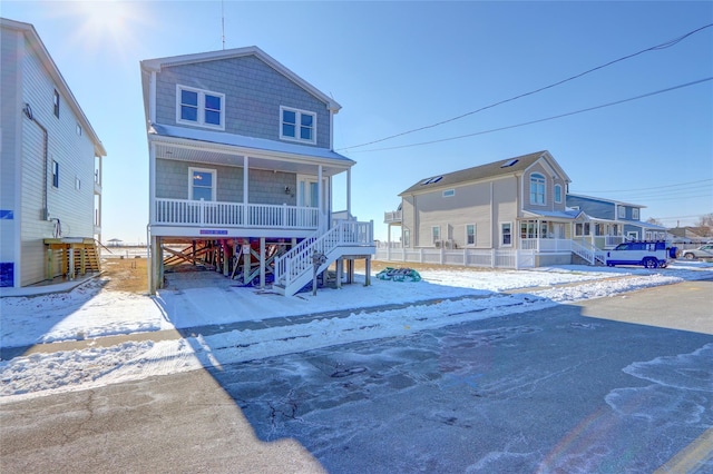 snow covered property with a porch