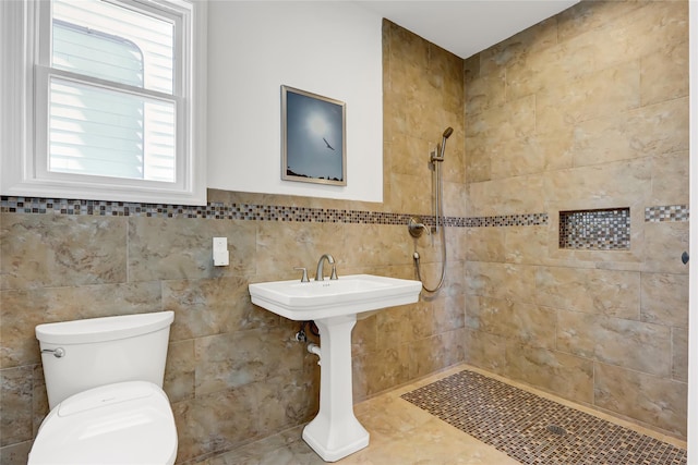 bathroom featuring toilet and a tile shower