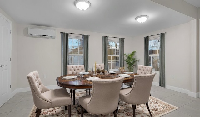 dining area featuring an AC wall unit, a healthy amount of sunlight, and light tile patterned flooring