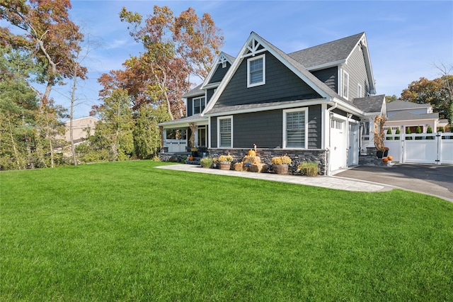 craftsman house with a porch, a garage, and a front lawn