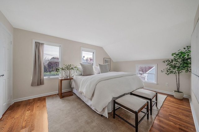 bedroom with wood-type flooring and lofted ceiling