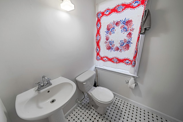 bathroom with tile patterned flooring, sink, and toilet