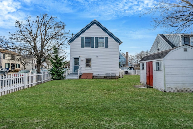 rear view of property with a storage shed and a lawn