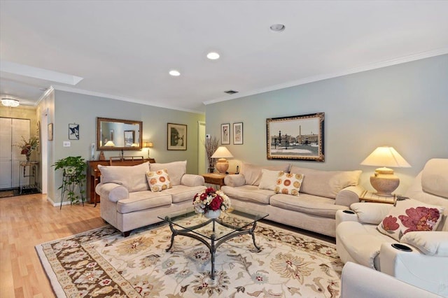 living room featuring ornamental molding and light wood-type flooring