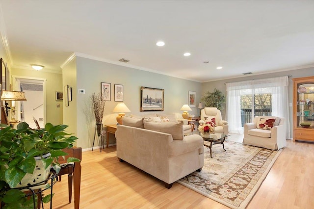 living room with crown molding and light wood-type flooring