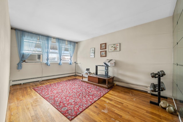 interior space featuring cooling unit, wood-type flooring, and a baseboard heating unit