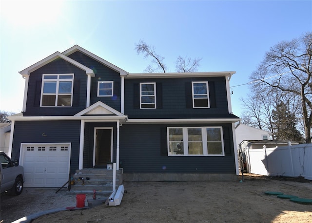 view of front of home featuring an attached garage and fence