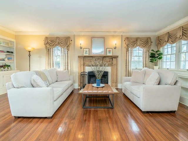 living room with crown molding, dark wood-type flooring, and a healthy amount of sunlight