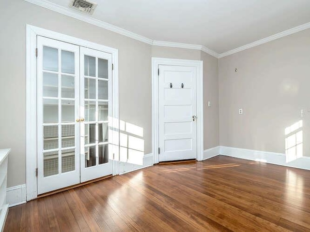 interior space featuring hardwood / wood-style flooring, crown molding, and french doors