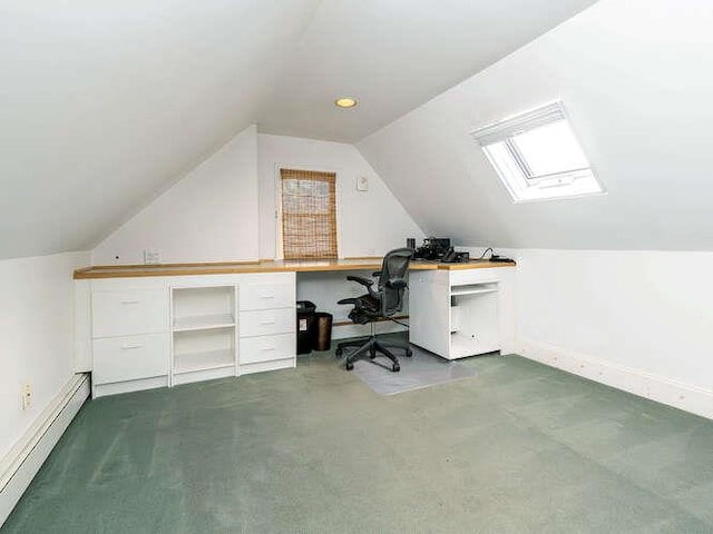 carpeted office with baseboard heating and vaulted ceiling with skylight