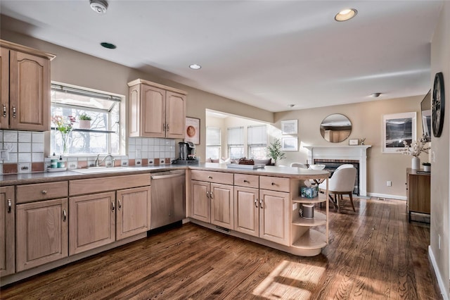 kitchen with sink, dishwasher, backsplash, dark hardwood / wood-style flooring, and kitchen peninsula