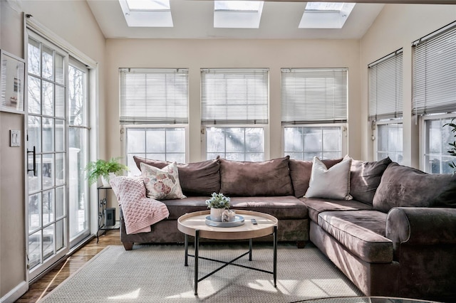 sunroom featuring vaulted ceiling with skylight