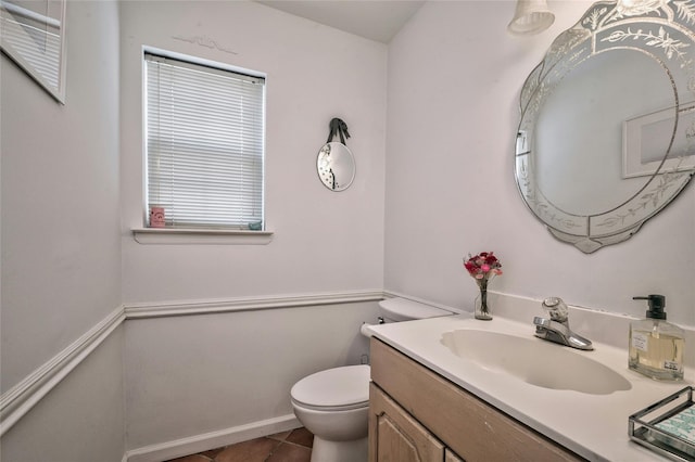 bathroom with vanity, tile patterned flooring, and toilet