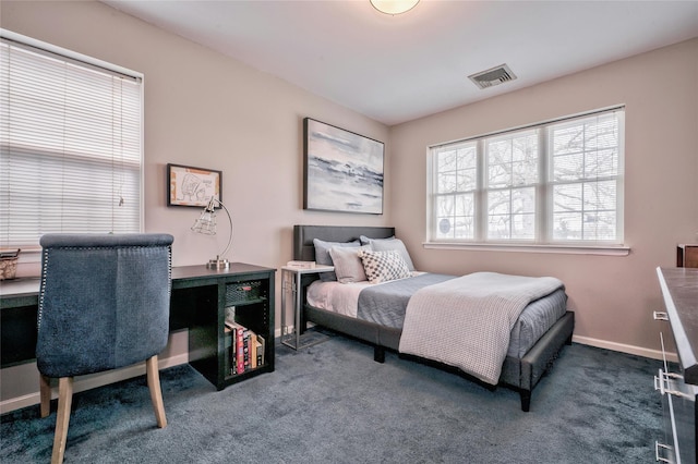 bedroom with dark colored carpet