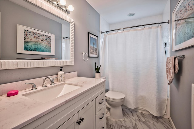 bathroom with vanity, toilet, and curtained shower