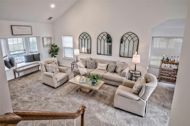 living room featuring carpet flooring and high vaulted ceiling