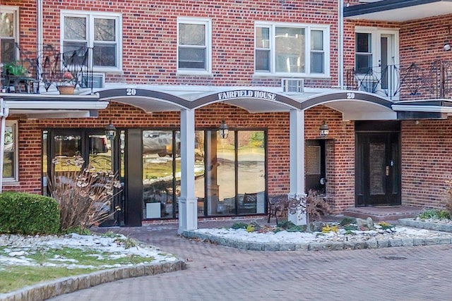 property entrance featuring brick siding