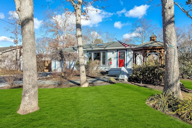 view of front of house featuring a gazebo and a front yard