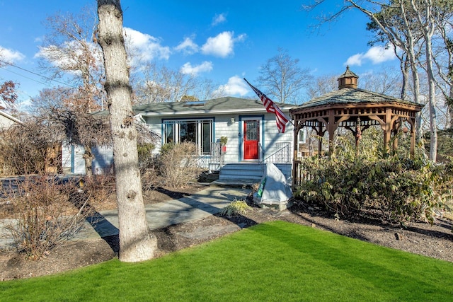 view of front facade with a gazebo and a front yard