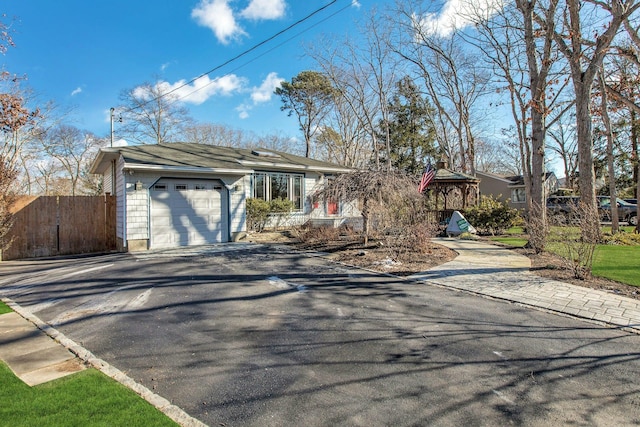 view of front facade featuring a garage and a gazebo