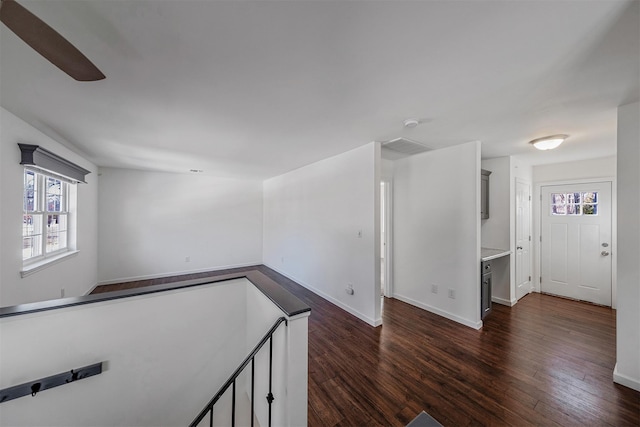 empty room with dark hardwood / wood-style flooring