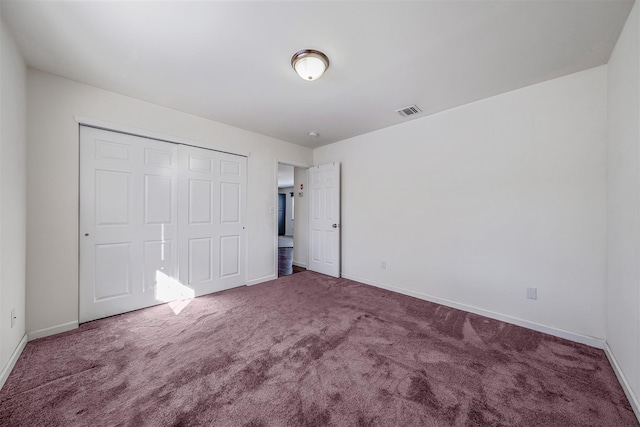 unfurnished bedroom with carpet floors and a closet