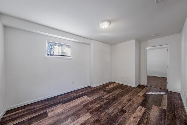 unfurnished room with dark wood-type flooring