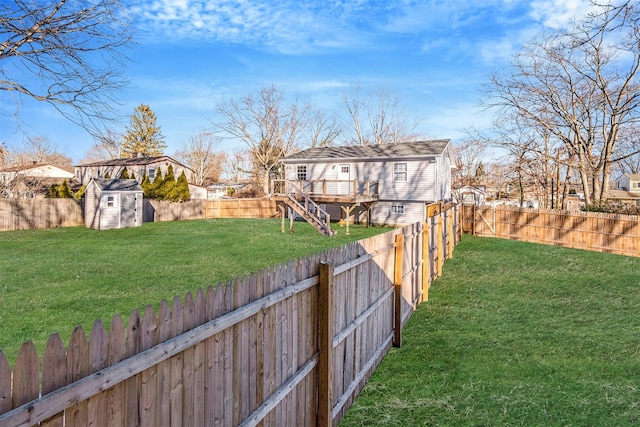 view of yard featuring a wooden deck and a shed