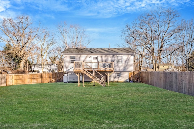 back of property with a lawn and a deck