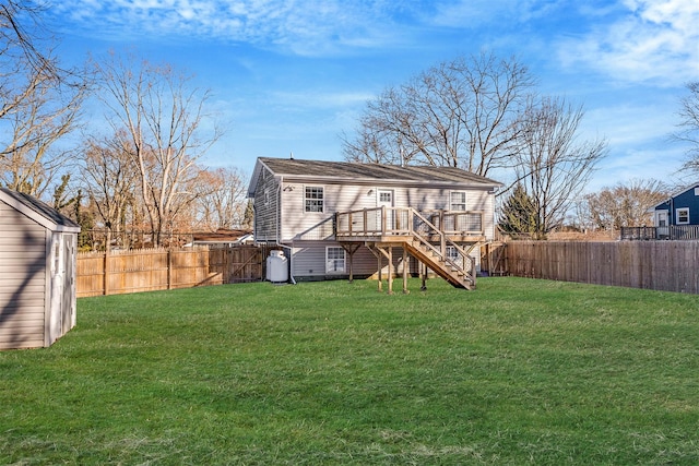 rear view of house with a wooden deck and a lawn