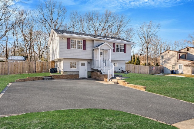 raised ranch with a front yard