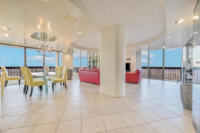 dining area featuring light tile patterned floors, expansive windows, an inviting chandelier, and a wealth of natural light