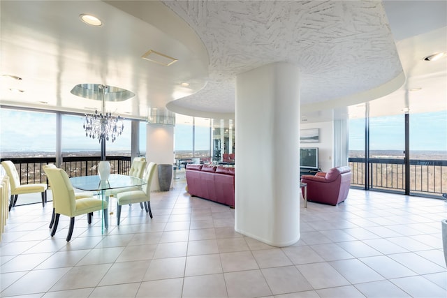 dining room featuring light tile patterned floors, floor to ceiling windows, and a chandelier