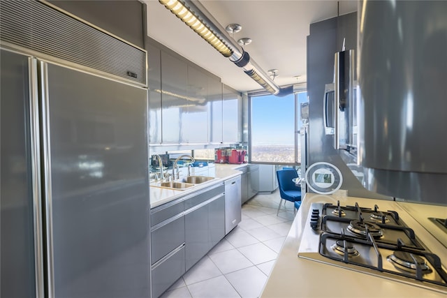 kitchen featuring sink, stainless steel appliances, and light tile patterned flooring