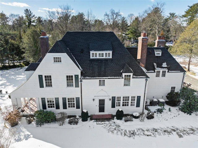 view of snow covered back of property