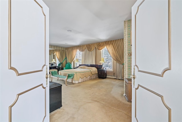 bedroom featuring carpet floors and a baseboard heating unit