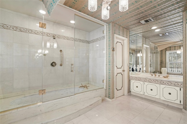 bathroom with vanity, tiled shower / bath combo, and tile patterned flooring