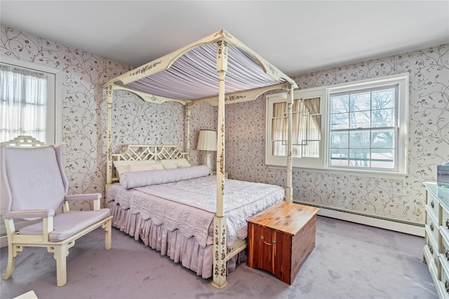 bedroom featuring baseboard heating, light colored carpet, and multiple windows