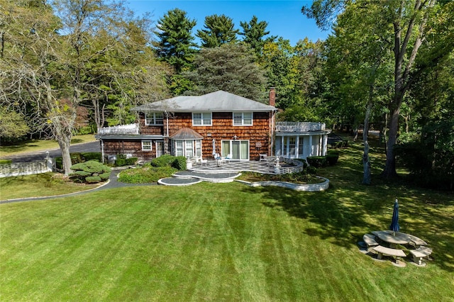 rear view of house featuring a yard