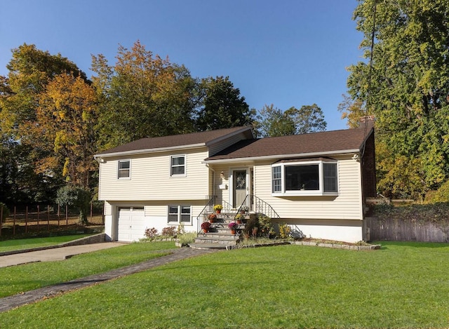 split level home with a front lawn and a garage