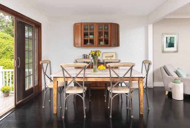 dining space with dark hardwood / wood-style flooring and french doors