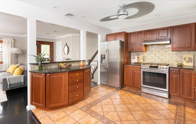 kitchen with dark stone counters, crown molding, ceiling fan, stainless steel appliances, and tasteful backsplash