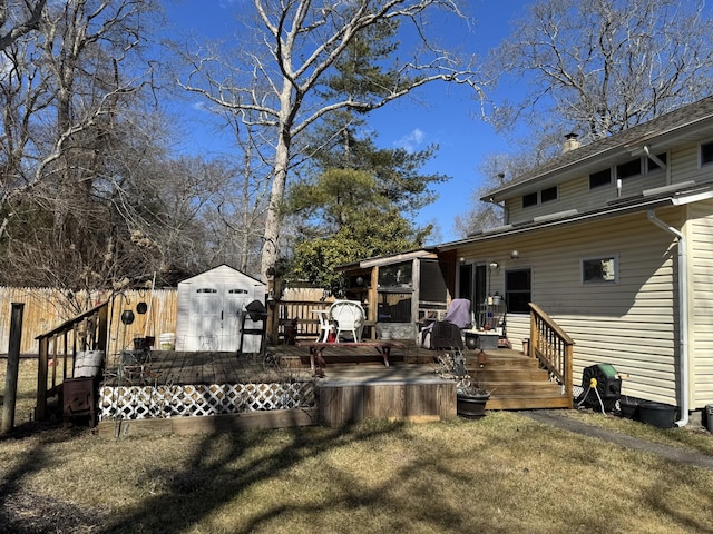 exterior space with an outbuilding, a shed, a wooden deck, and fence