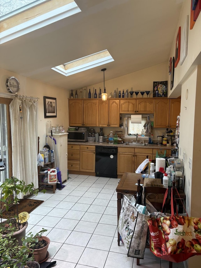 kitchen featuring stainless steel microwave, lofted ceiling with skylight, dishwasher, light tile patterned floors, and a sink