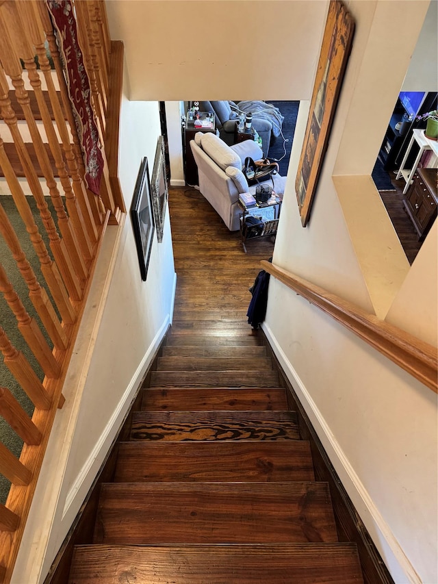 staircase featuring wood finished floors