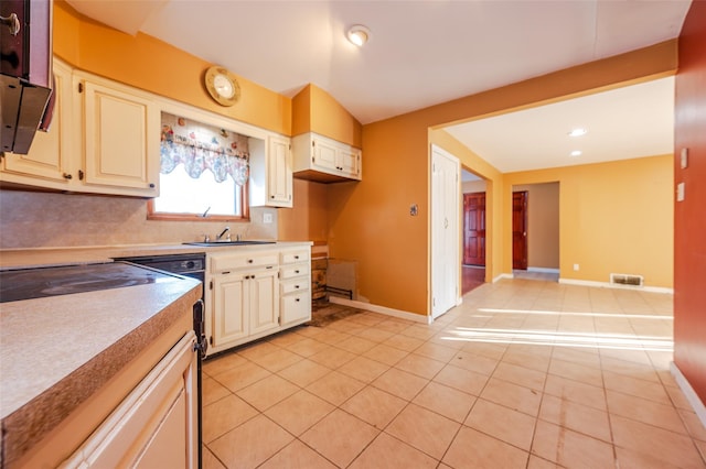 kitchen featuring sink, decorative backsplash, and light tile patterned floors