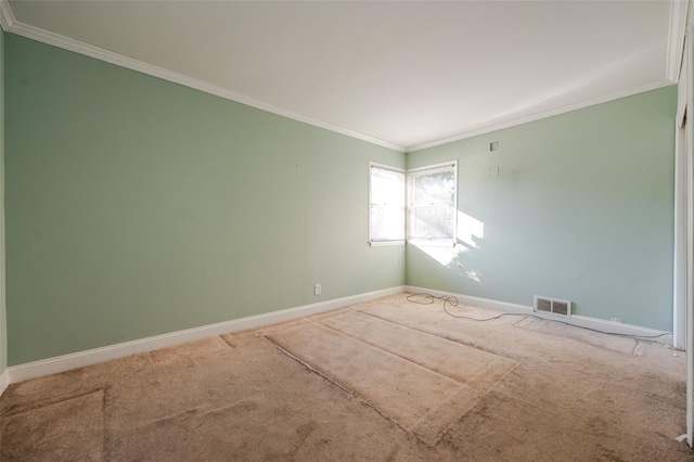 unfurnished room with ornamental molding and carpet flooring