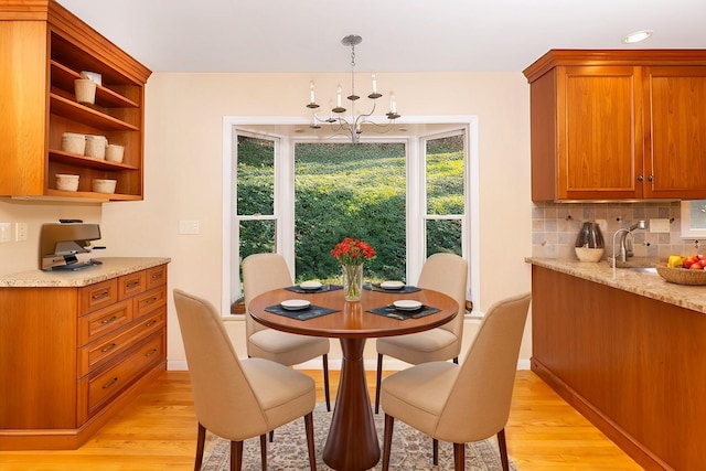 dining room with a chandelier and light wood-type flooring